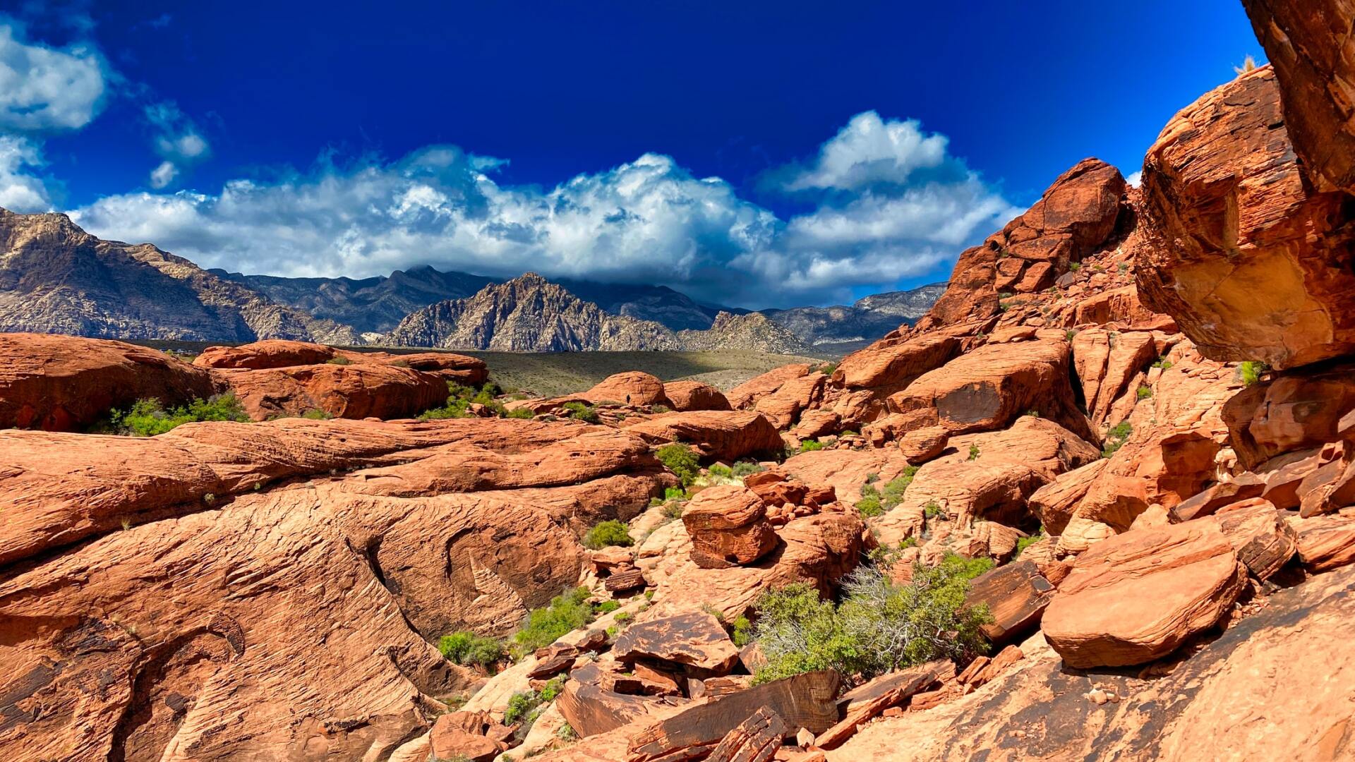view of Red Rock canyon with mountains and clouds in background
