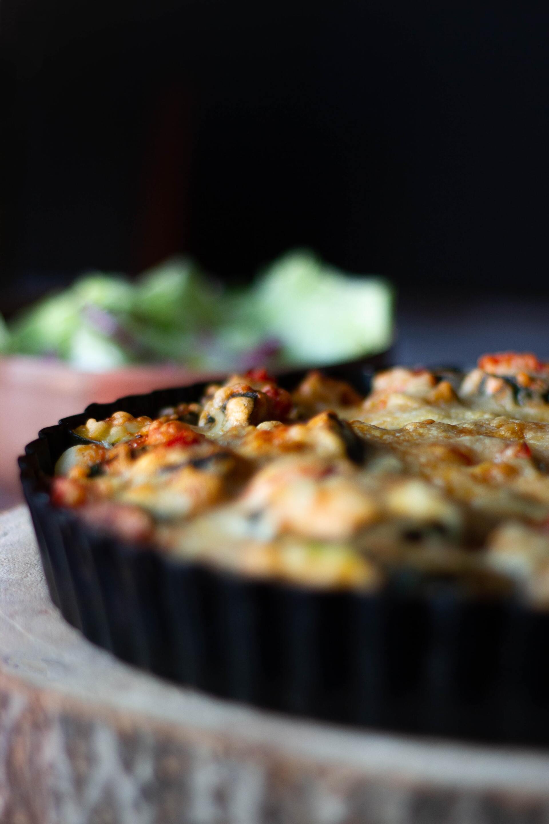 a close up of a pie on a wooden cutting board
