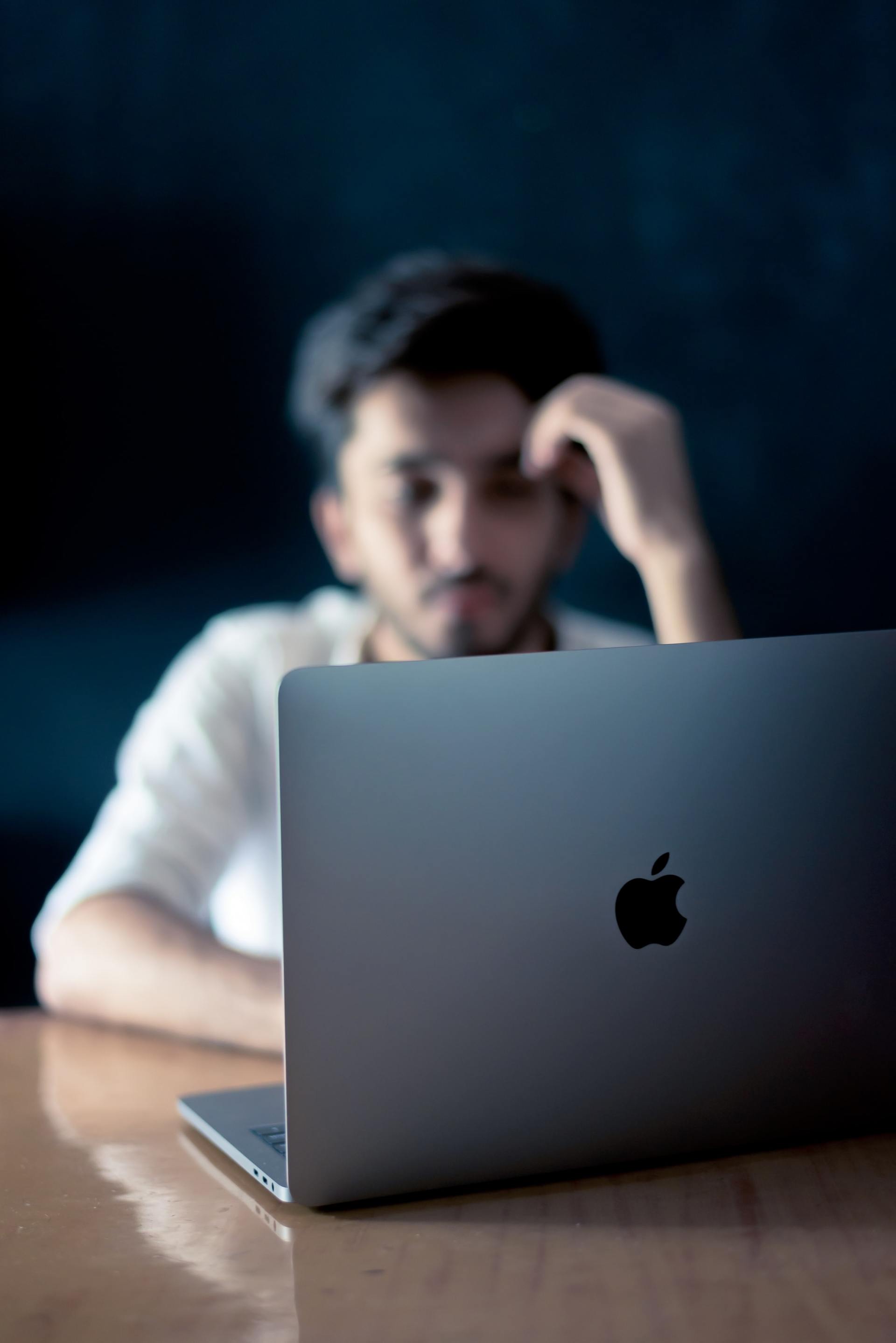 image of man looking at a laptop screen