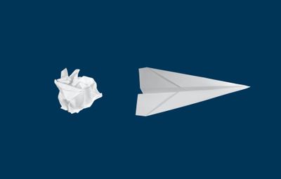 A crumpled piece of paper next to a paper airplane on a blue background