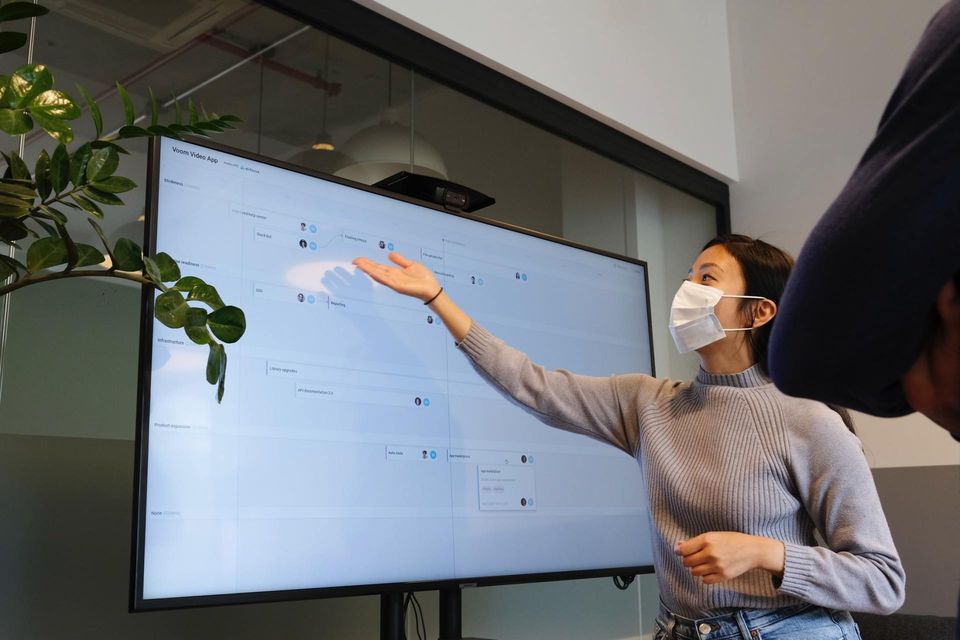 Teacher with mask at a digital screen