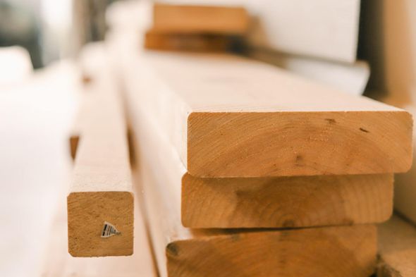 Showcasing stacked lumber Construction Material Cost Forecast 2021