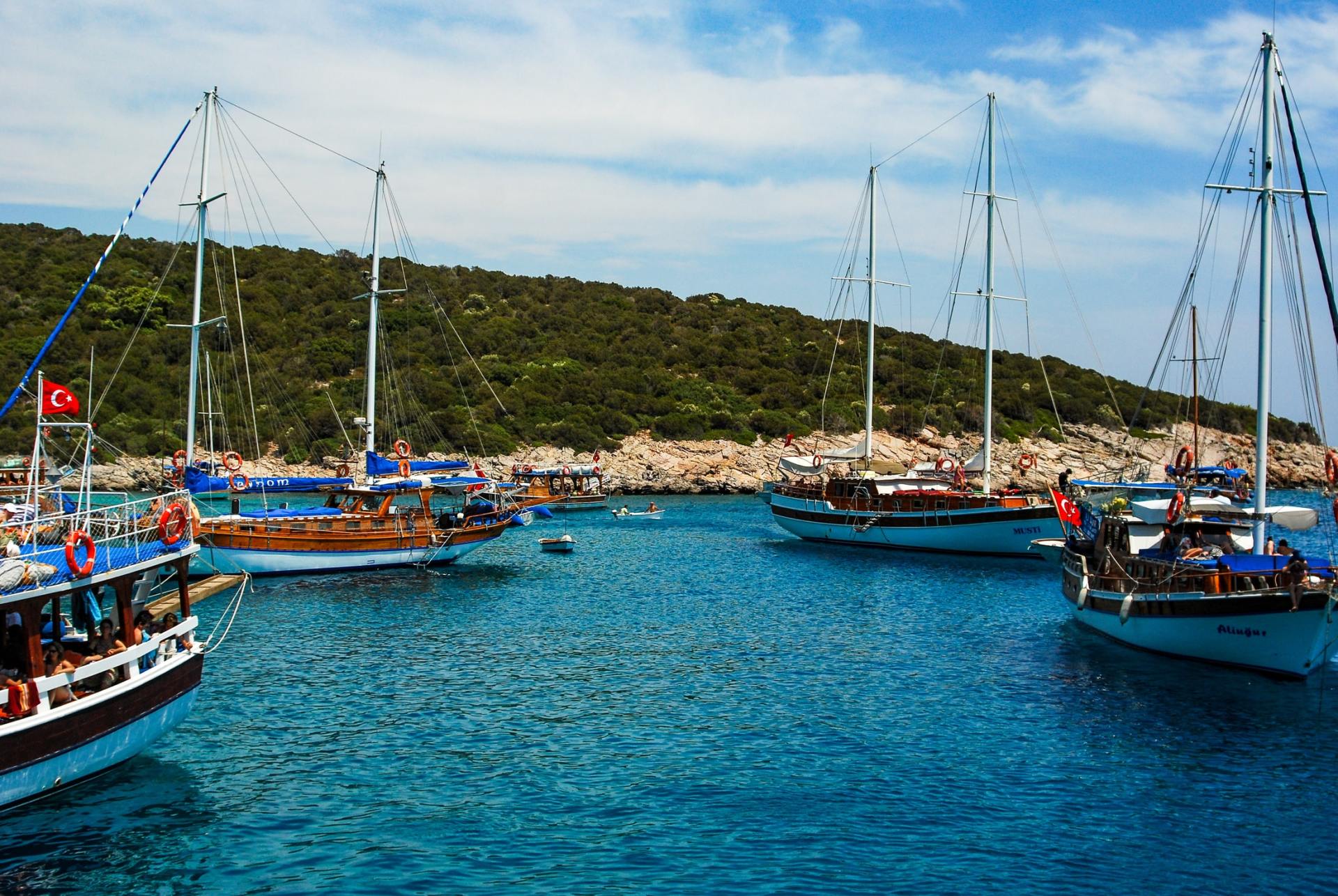 A group of boats are floating on top of a body of water.