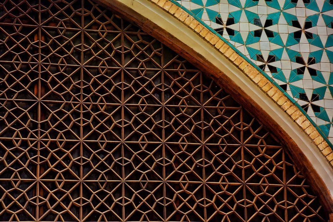 A close up of a wooden arch with a pattern on it