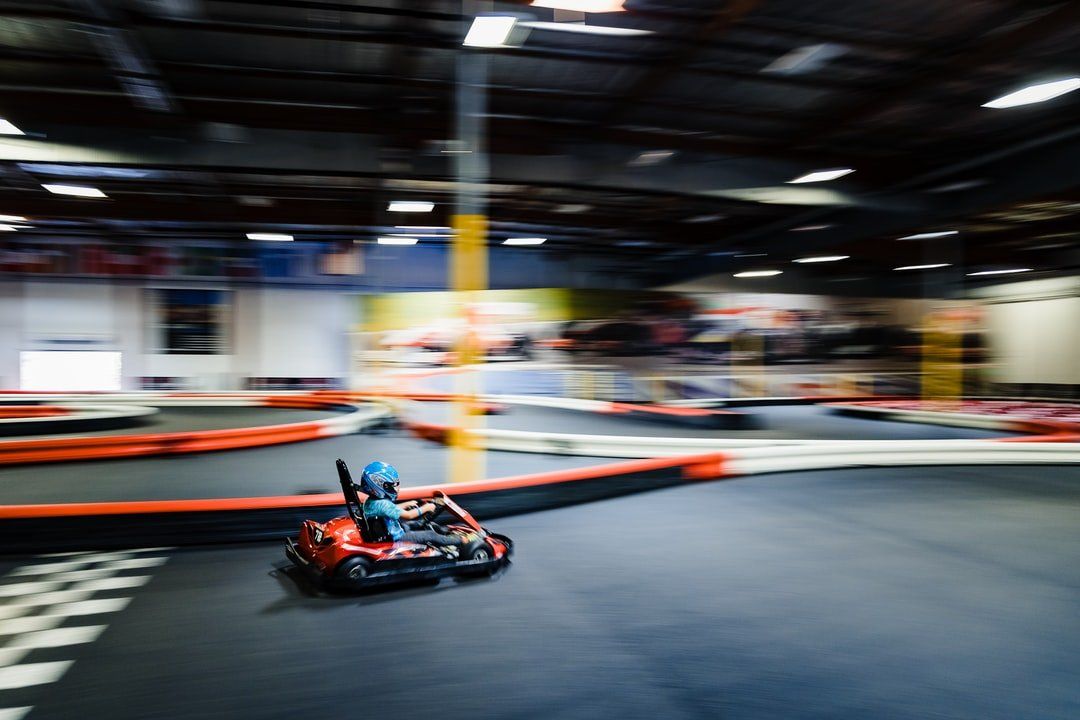 A person is riding a go kart on a track.