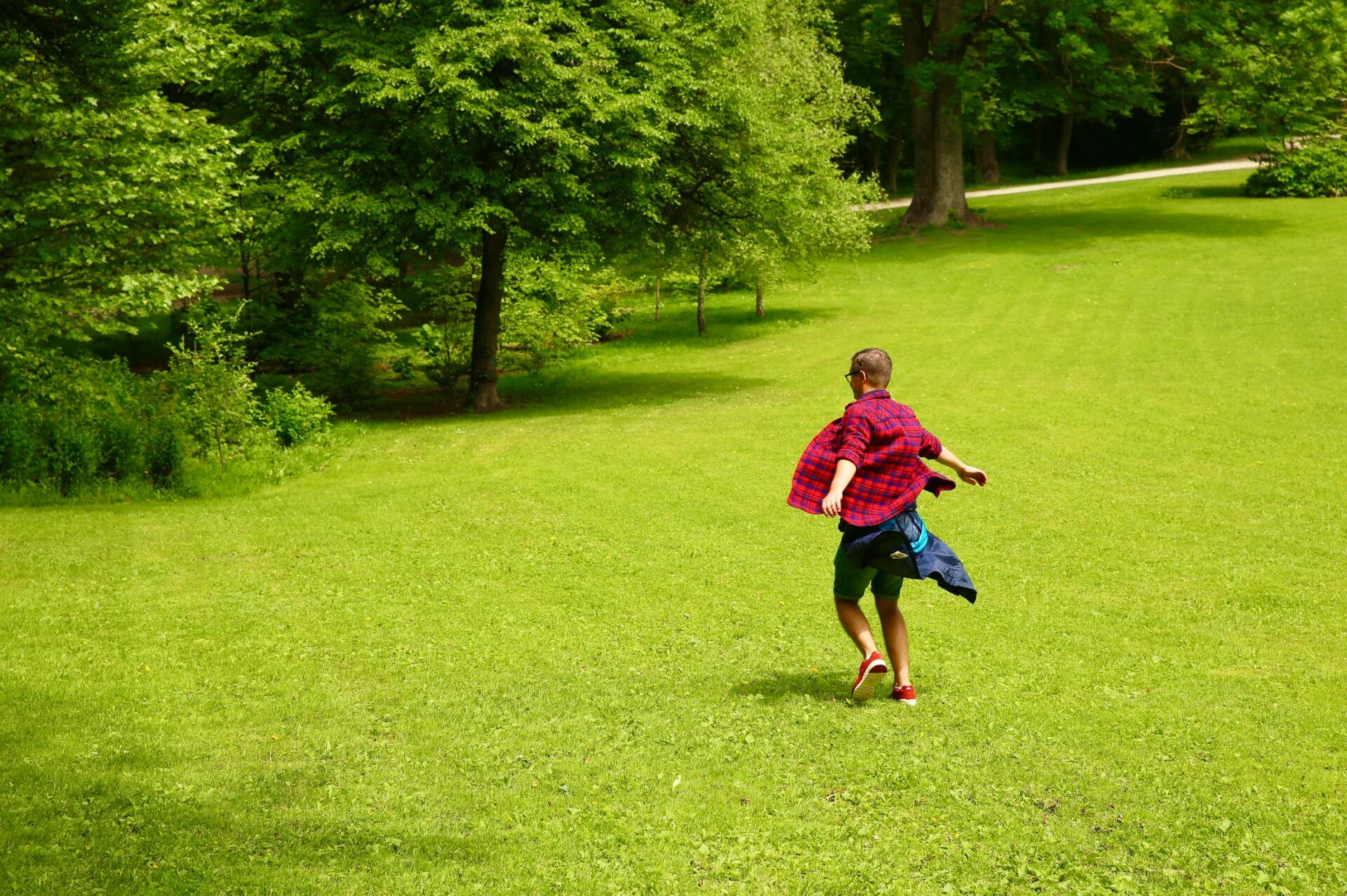 Kids playing in yard in green mowed grass