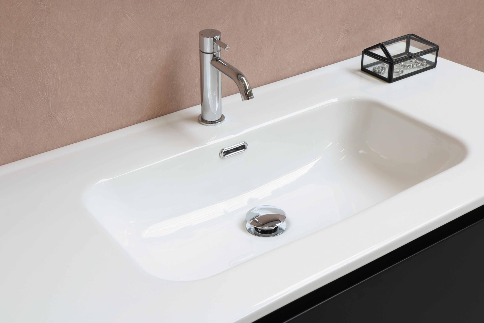 a white square sink with chrome faucet