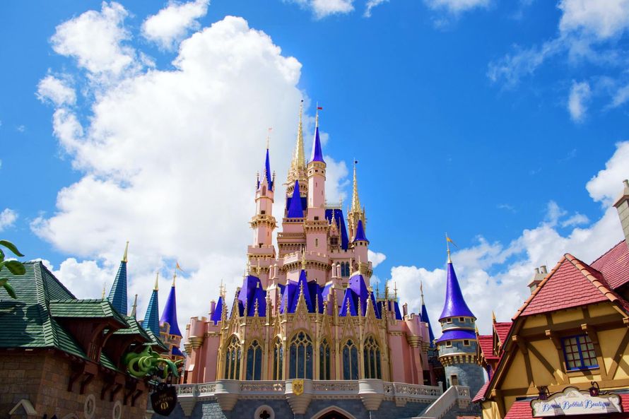 A pink castle with purple towers and a blue sky in the background