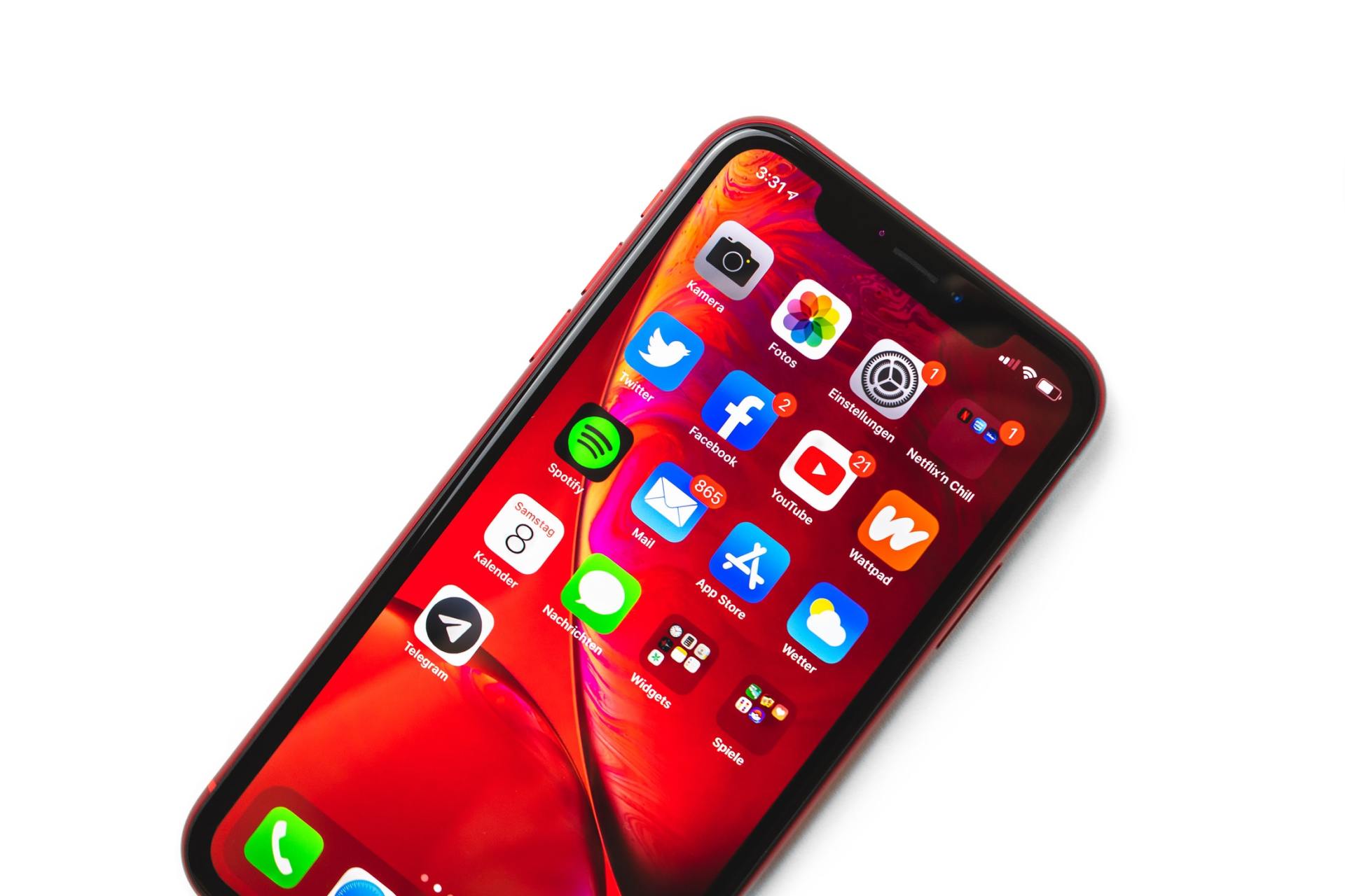 A red iphone with a bunch of apps on it