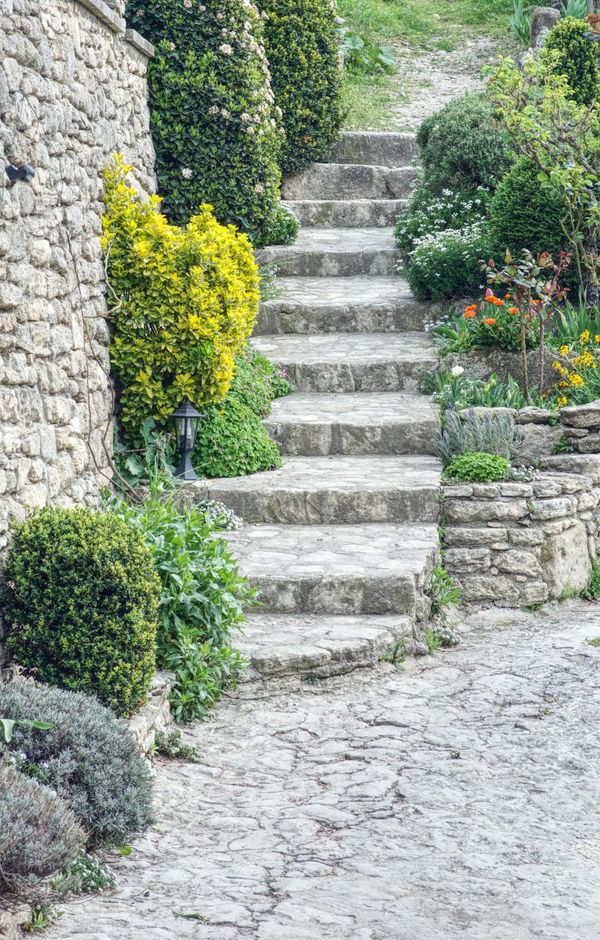 stone landscape walkway with high retaining wall