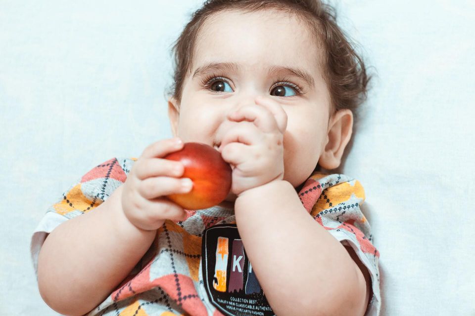 baby eating apple