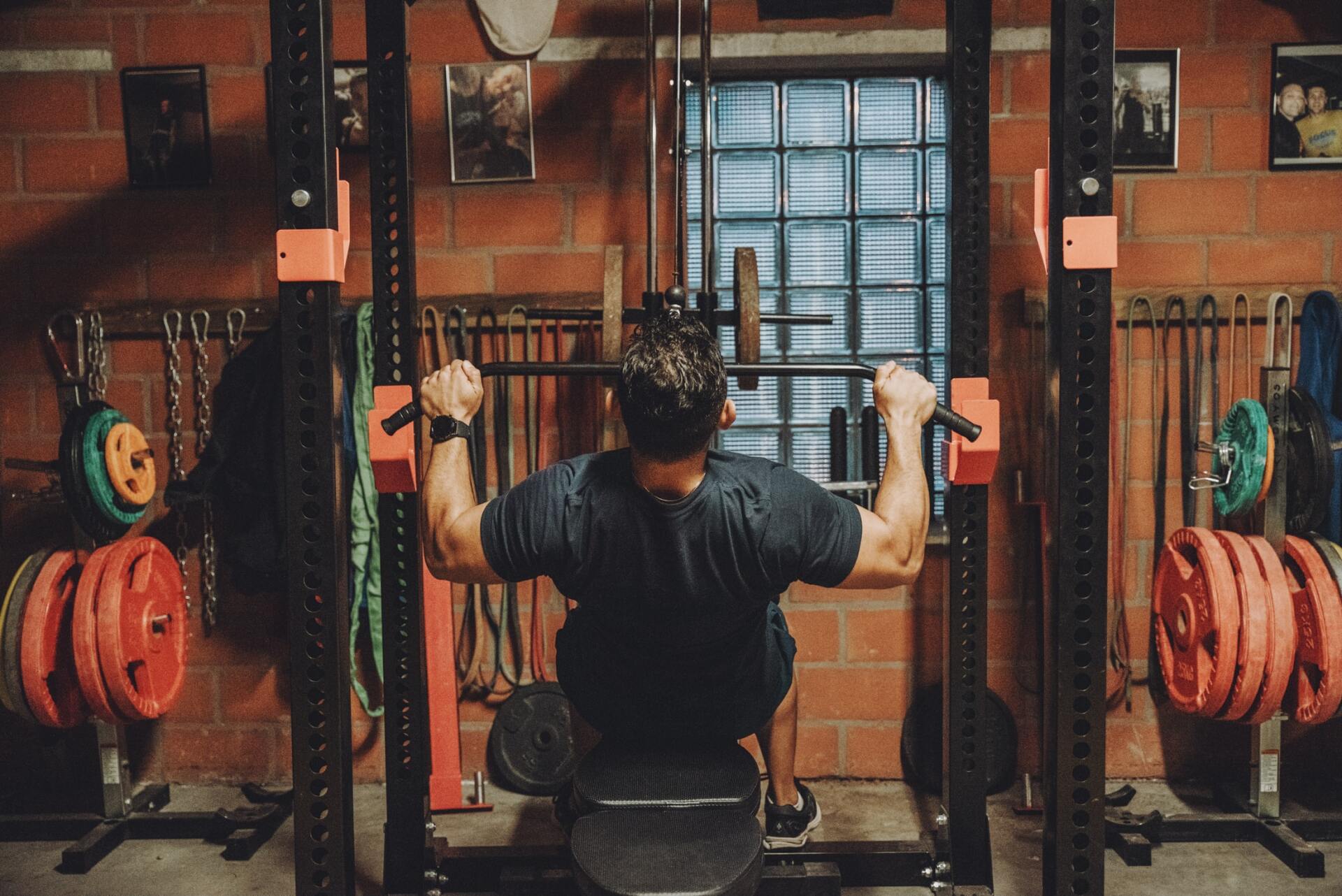 a man is doing a lat pulldown in a gym