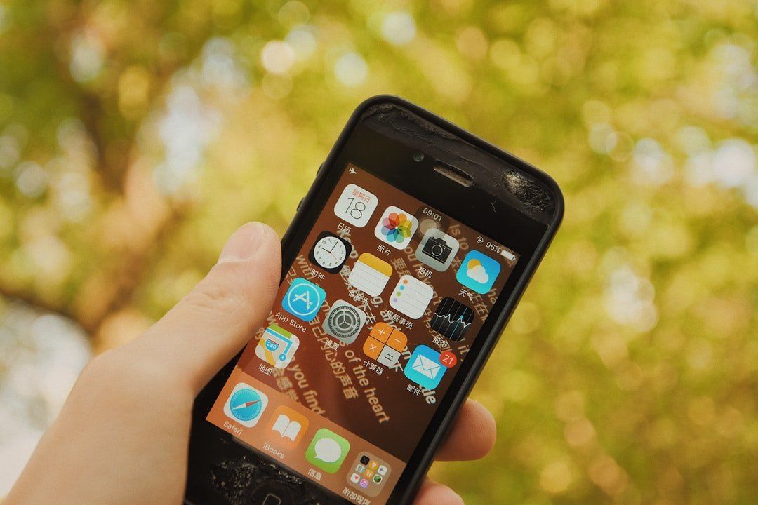 A person is holding a cell phone in their hand.