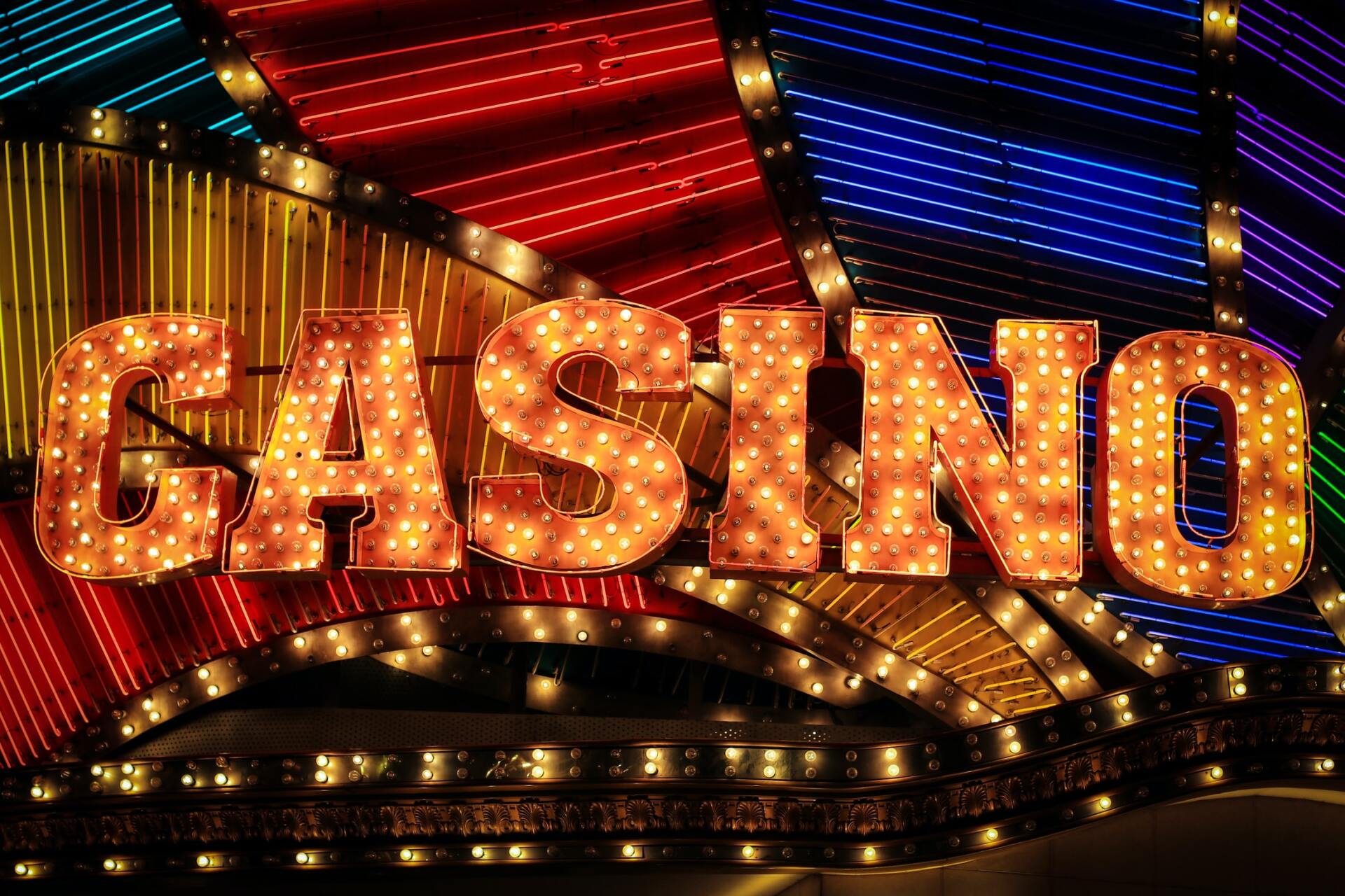 A colorful sign that says casino with lights on it