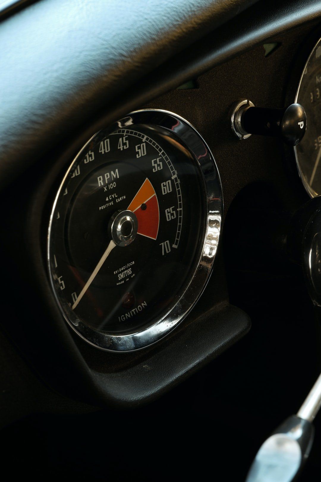 A close up of a rpm gauge in a car