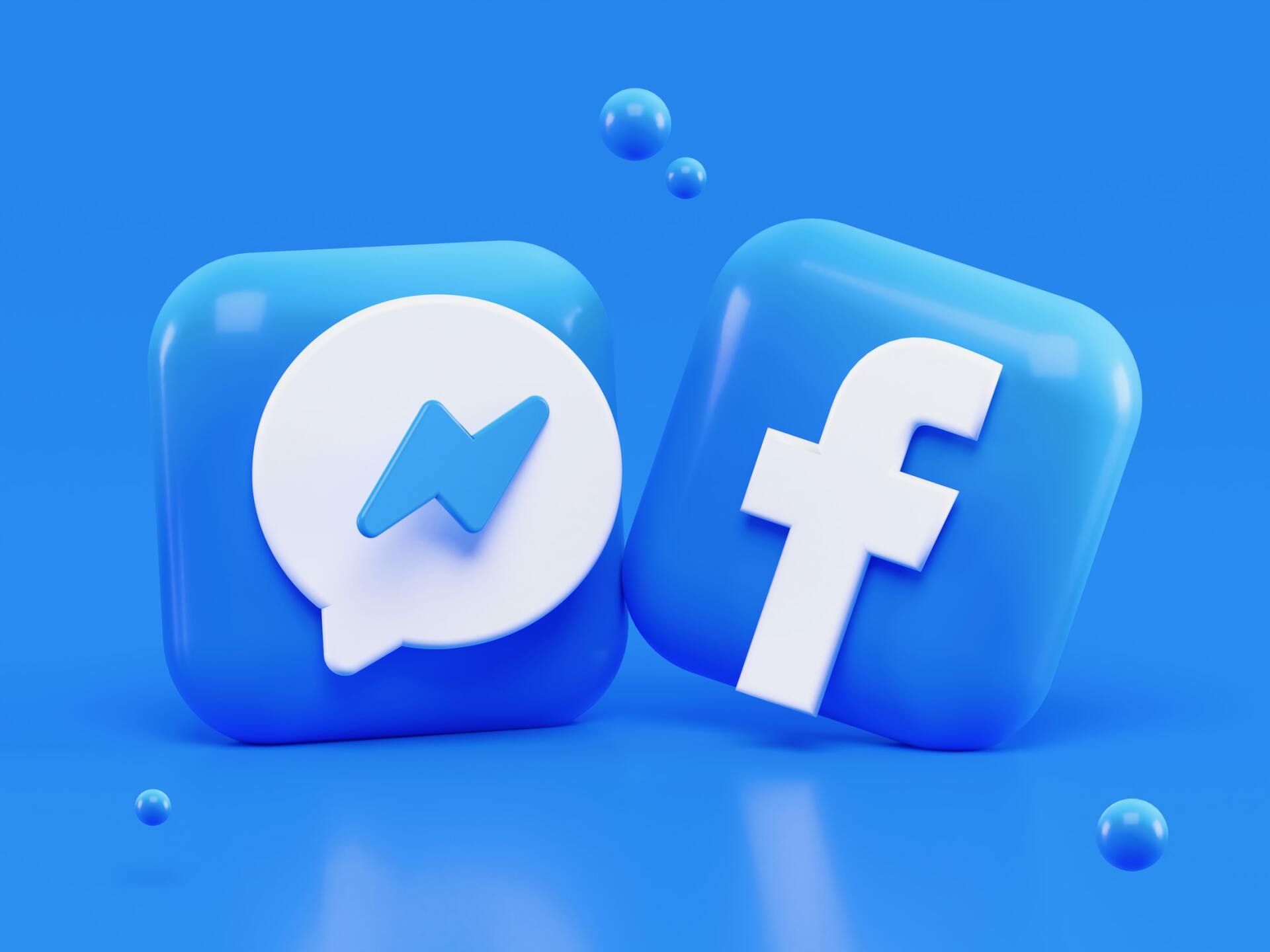 two facebook icons are sitting on top of each other on a blue background .