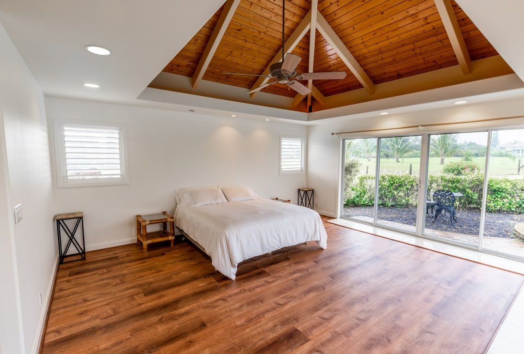 Bedroom With Large Window and Wooden Floors