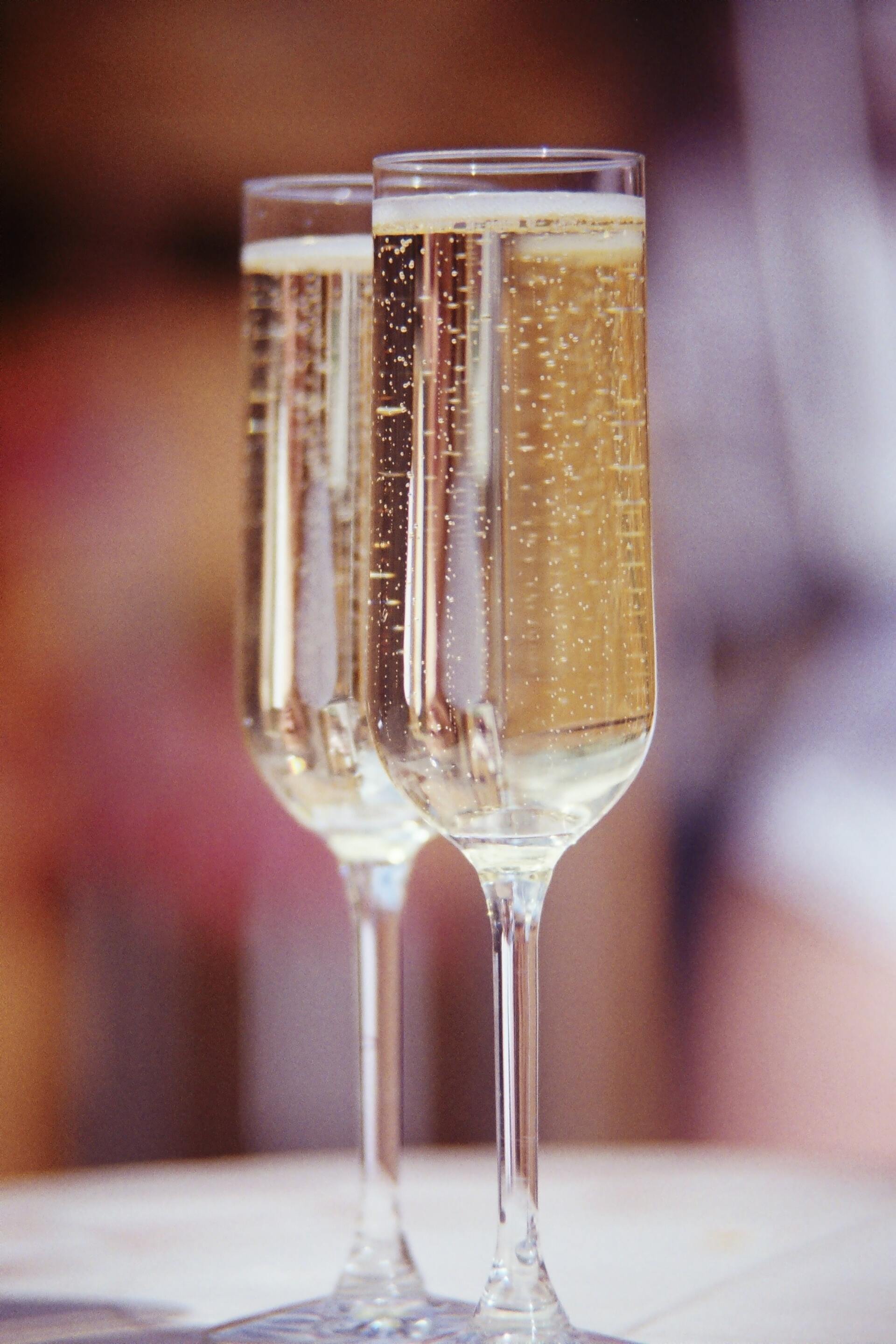 Two glasses of champagne are sitting on a table