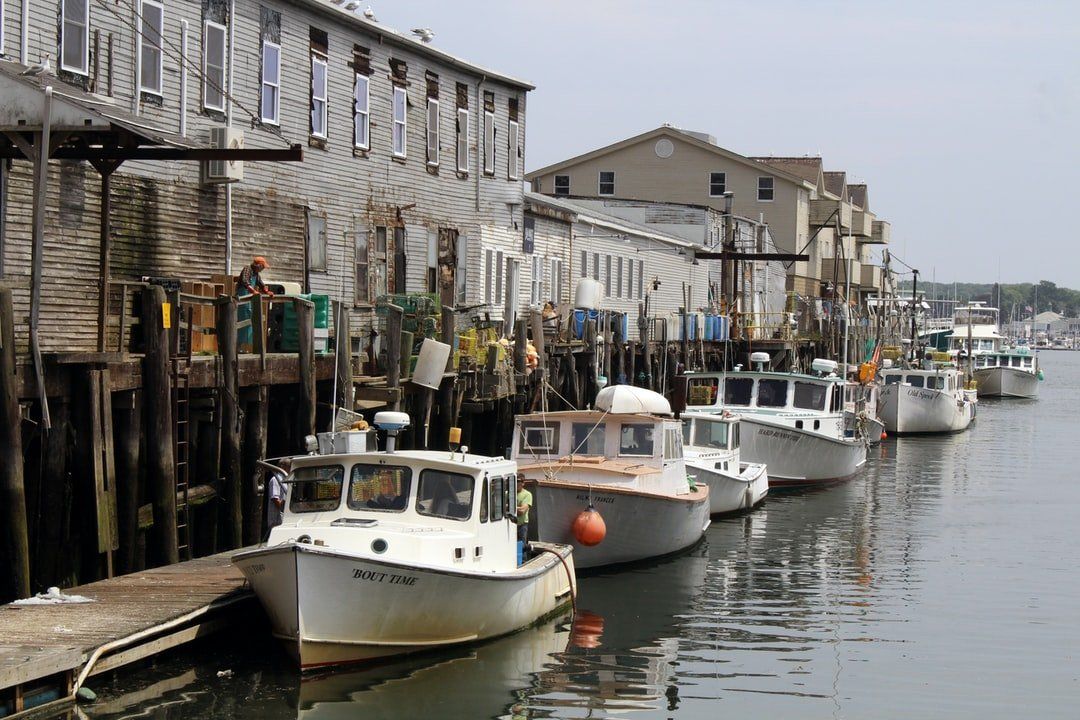 A photo of boats docked along a pier