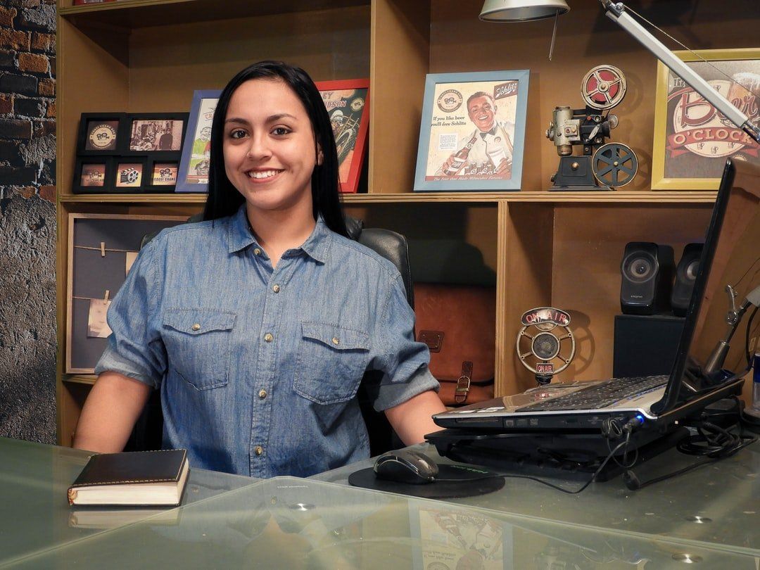 Kristy sitting at the front desk helping a customer