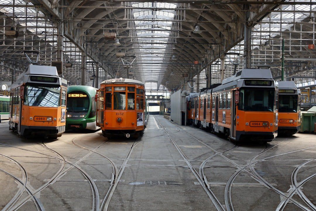 A row of trolleys are parked in a large building