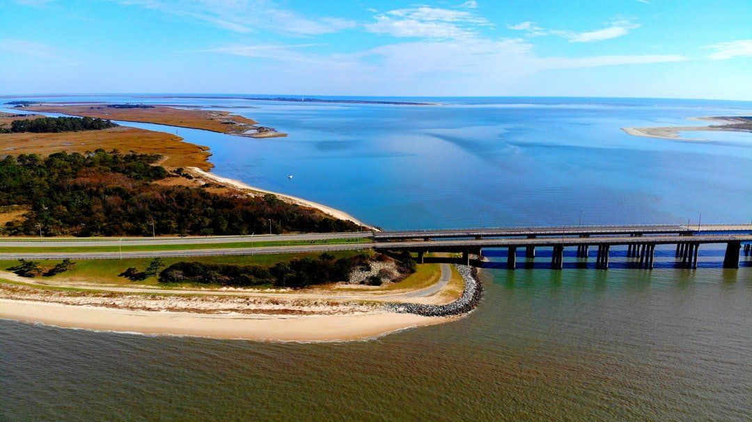 An aerial view of a bridge over a body of water.