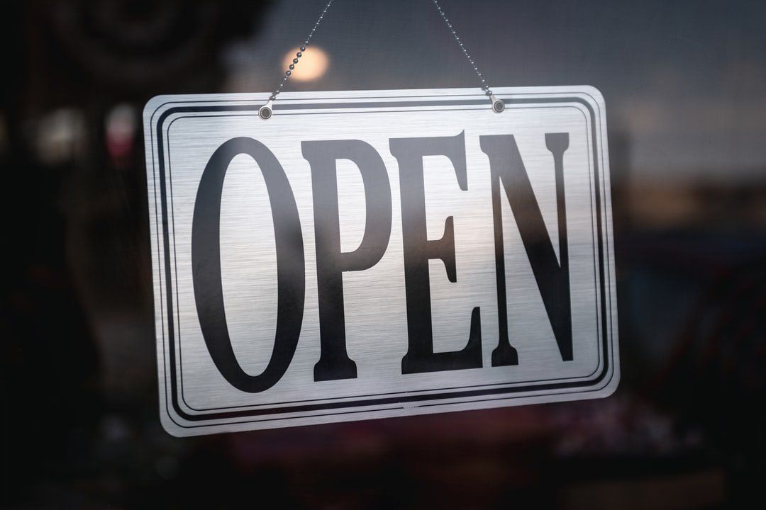 An open sign is hanging in a window.
